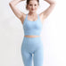 Set Original by Gymtuned în albastru pastel – bustieră sport pentru fitness si sala și colanți modelatori seamless fără cusături, purtate de model.
